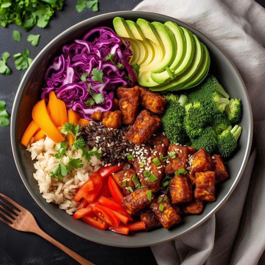 Vegan tempeh bowl with crispy tempeh, vegetables and grains