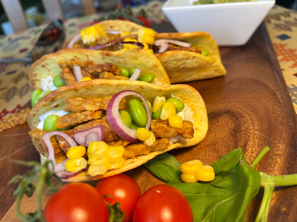 Tempeh tacos. Tacos filling of tempeh, rice, edamame beans, and onion with some vegetarian mayo. 